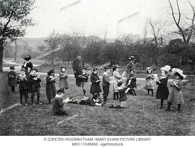 Children from the London School Board's Clyde Street School with their sketch books in Deptford Park