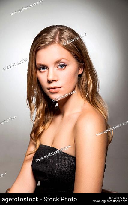portrait of beautiful woman with blonde wavy hair looking at camera.Studio shot