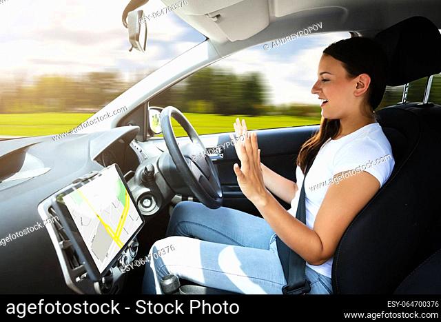 Side View Of A Young Woman Sitting In Self Driving Modern Car