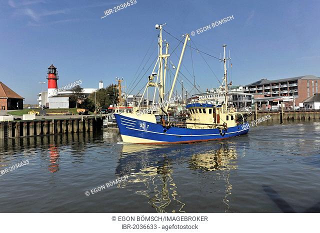 Shrimp cutter in the port of Buesum, with Buesum Lighthouse on the left, Schleswig-Holstein, Germany, Europe