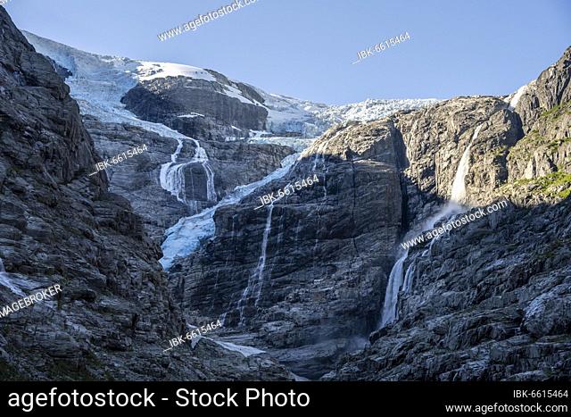 Waterfalls on steep cliff, Kjenndalsbreen glacier, Loen, Vestland, Norway, Europe