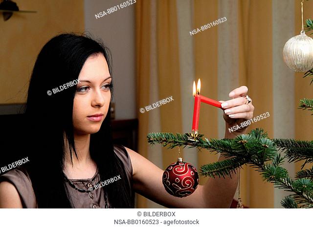 Woman with Christmas tree and Christmas candle for Christmas