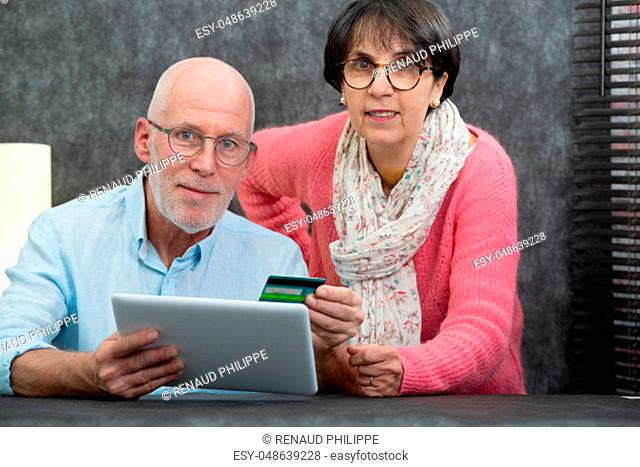 happy senior couple using a digital tablet