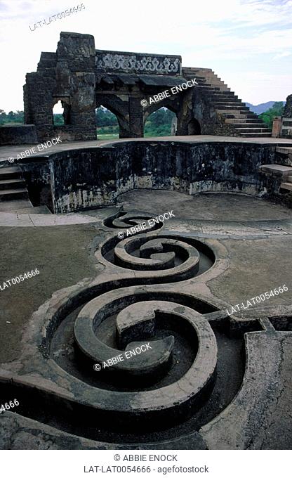 Elaborate stone carved curved water cooling channels at the Jahaz Mahal or Ship Palace
