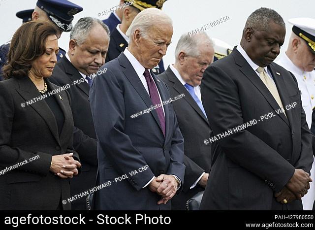 From left to right: United States Vice President Kamala Harris, US President Joe Biden and US Secretary of Defense Lloyd Austin bow their heads during a...