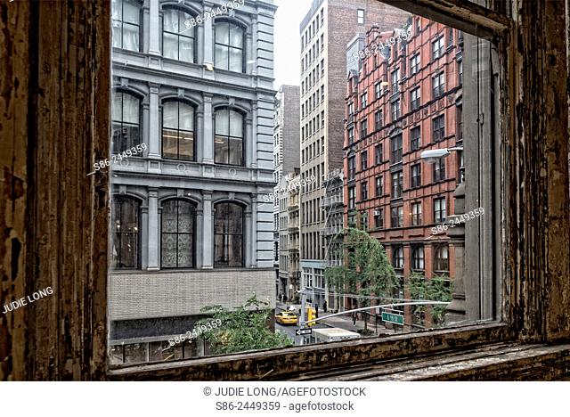 Looking out the window of a Flat Iron building at the Flatiron District of New York City, on a Rainy Day