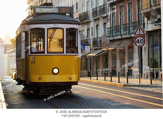 Lisbon's traditional yellow tram on the 28 line, passing at Calçada do Combro, the street that divides Bairro Alto and Bica neighborhoods
