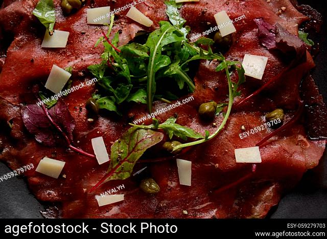 Beef Carpaccio with parmesan, capers and arugula. With olive oil and soy sauce