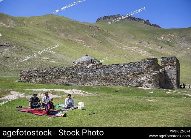 Family on picnic in the Tash Rabat caravanserai, Naryn region, Kyrgyzstan. Silk Road