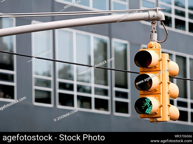 Yellow traffic lights with green pass sign on. New York USA