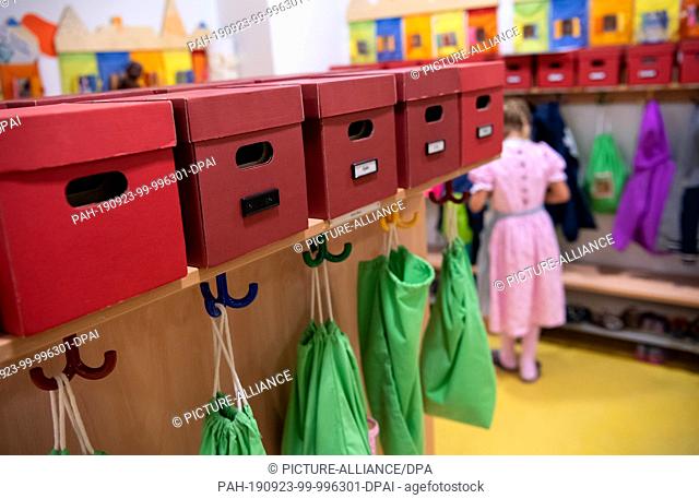 23 September 2019, Bavaria, MŸnchen: Jackets and gym bags hang from the wardrobe during a tour of the Municipal House for Children
