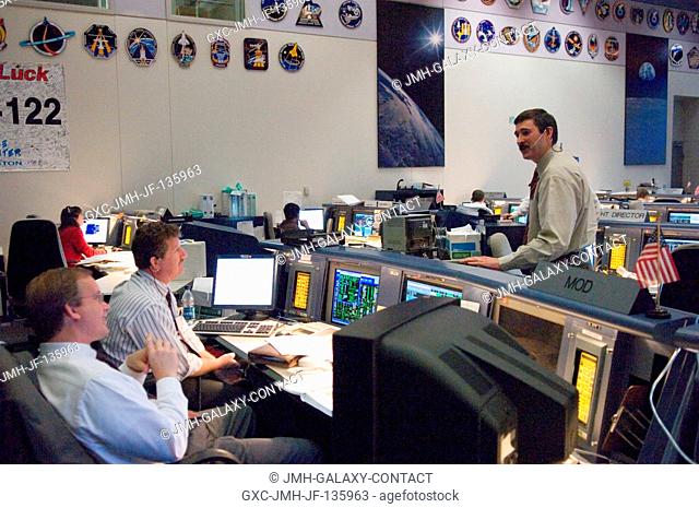 Flight director Mike Sarafin (standing); Phil Engelauf, JSC flight director office chief; and John Shannon (foreground), deputy shuttle program manager