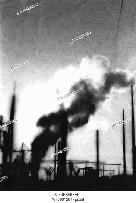 Smoke rising from chimneys at a factory