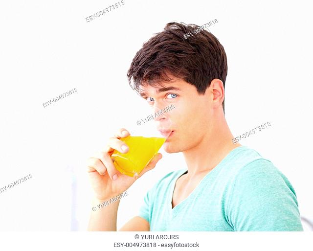 Handsome young guy drinking orange juice - portrait