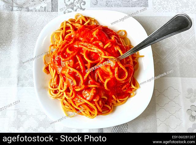 top view of plate of spaghetti with tomato sauce. Italian food. Portion of pasta