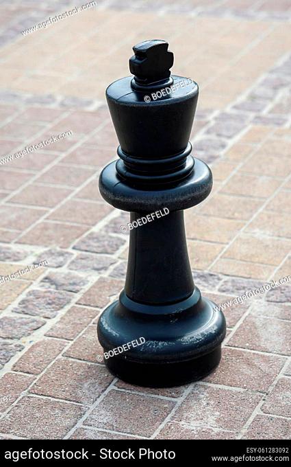 Chess pieces on an outdoor chess board. Chess the game with strategy