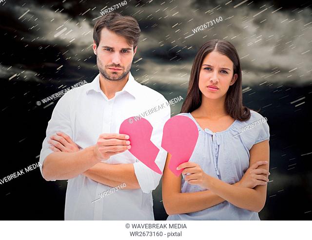 Depressed couple holding broken heart
