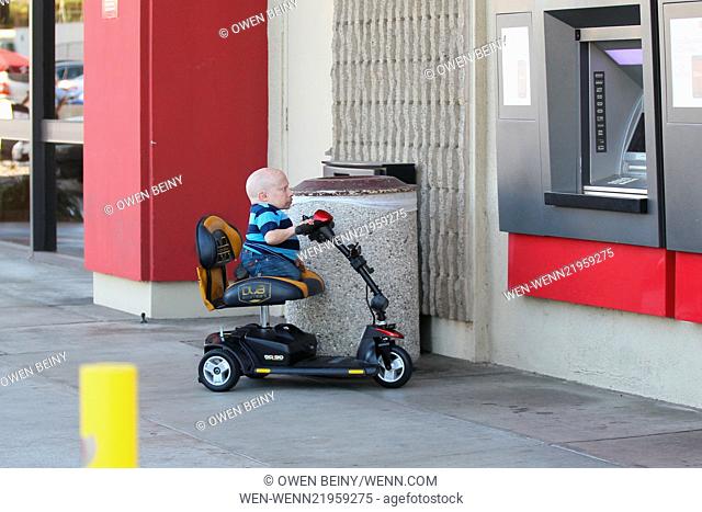 Verne Troyer gets money out of an ATM by climbing on his motor scooter Featuring: Verne Troyer Where: Los Angeles, California