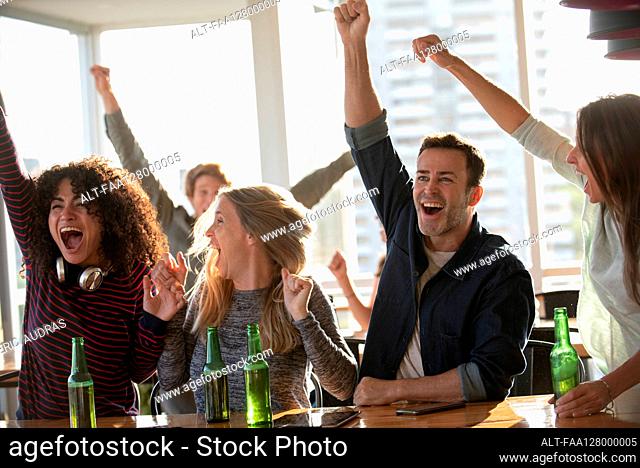 Excited business people celebrating in office