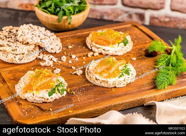 Delicious smoked salmon and cream cheese on rice bread toasts