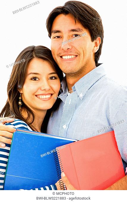 happy smiling couple of students with colourful notebooks