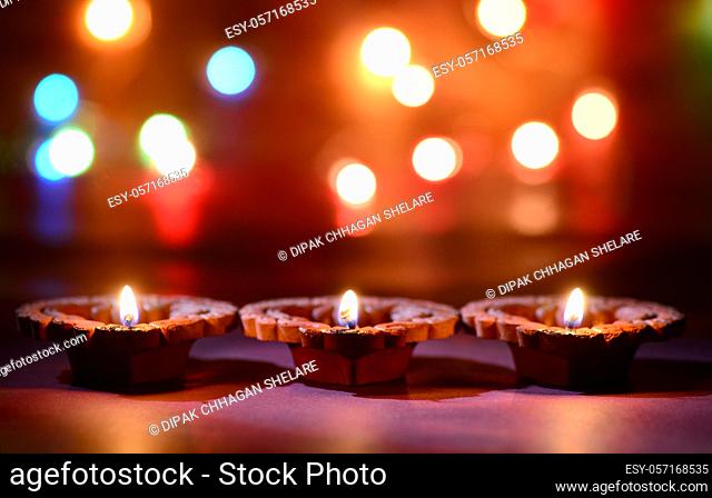 Clay diya lamps lit during diwali celebration. Greetings Card Design Indian Hindu Light Festival called Diwali
