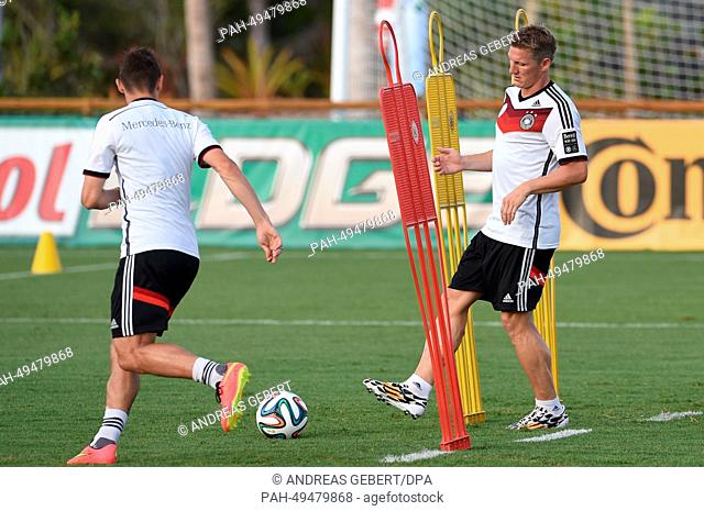 Bastian Schweinsteiger (R) and Miroslav Klose in action during a training session of the German national soccer team in Santo Andre, Brazil, 18 June 2014