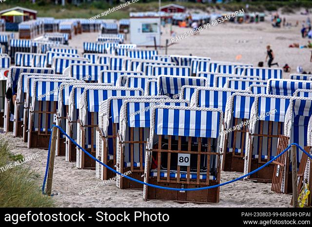 03 August 2023, Mecklenburg-Western Pomerania, Boltenhagen: Empty beach chairs stand next to the pier on the Baltic Sea coast