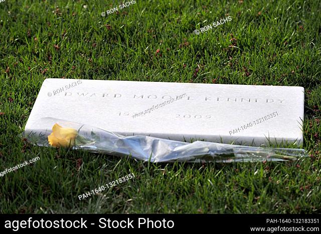 Grave of former United States Senator Edward M. ""Ted"" Kennedy (Democrat of Massachusetts) with a single yellow rose at the marble marker at Arlington National...