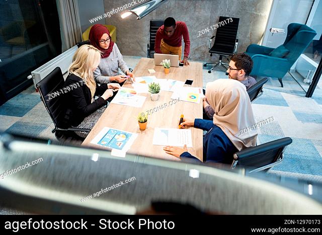 Multi-Cultural Office Staff Sitting Having Meeting Together