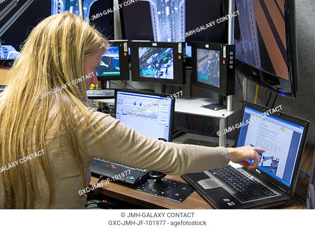 NASA astronaut Karen Nyberg, Expedition 3637 flight engineer, uses the virtual reality lab in the Space Vehicle Mock-up Facility at NASA's Johnson Space Center...