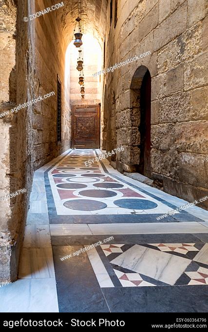Vaulted passage leading to the Courtyard of Sultan Qalawun mosque with geometrical pattern colorful marble floor, Moez Street, Old Cairo, Egypt