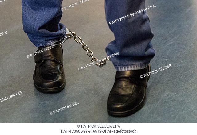The defendant Hussein K. is brought back into the court room wearing shackles after a break during his trial in Freiburg, Germany, 5 September 2017