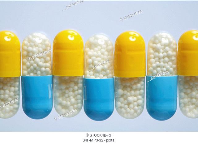 Blue and yellow capsules in a row