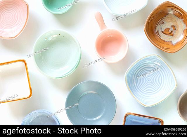 Colorful empty plates on white background. flat lay, top view