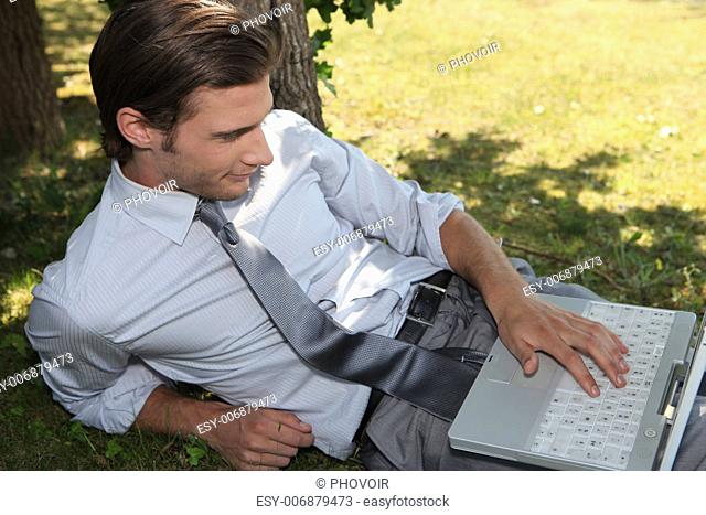 Young executive working in the park