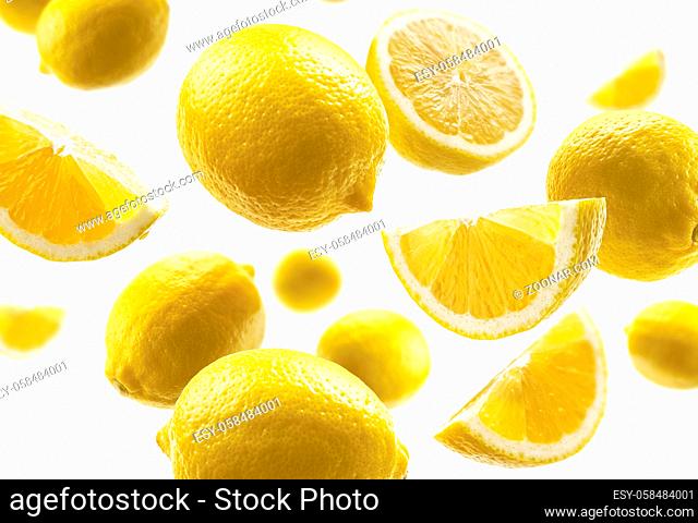 Yellow lemons levitate on a white background