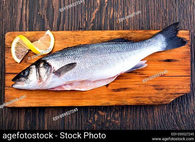 Raw Seabass isolated on a wooden table