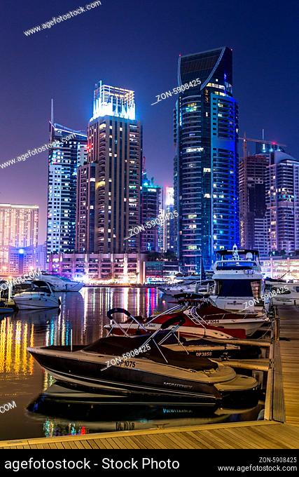 DUBAI, UAE - NOVEMBER 13: Dubai downtown night scene with city lights, luxury new high tech town in middle East. Dubai Marina cityscape, on November 13