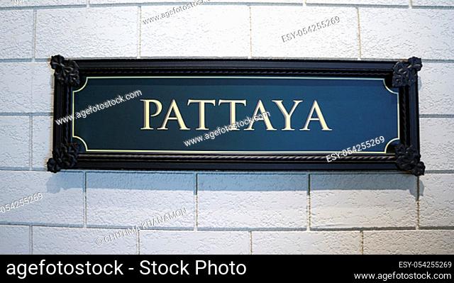 white wall sign frame pattaya city plaque green rusty