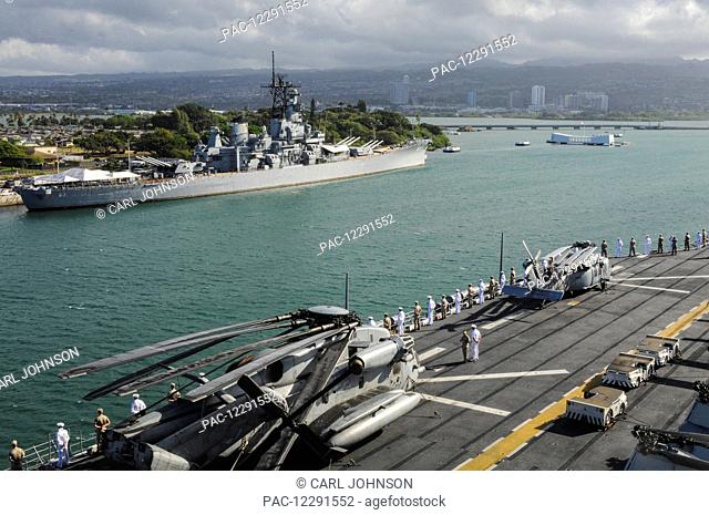 Sailors and Marines man the rails in dress uniform as a ship passes by the USS Missouri (BB-63) in Pearl Harbor; Oahu, Hawaii, United States of America