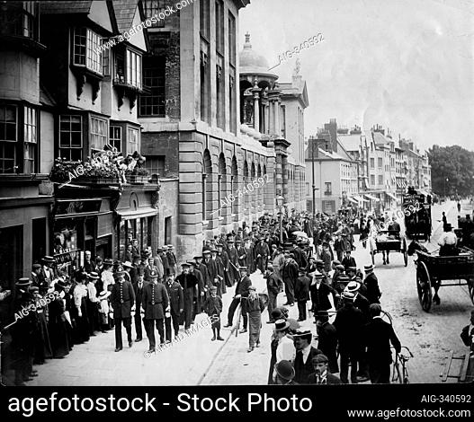 High Street, Oxford, Oxfordshire. A view of the High Street with Queen's College on the left, showing the University procession of Encaenia on its way to the...