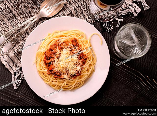 Top view of traditional Italian spaghetti bolognese on white plate