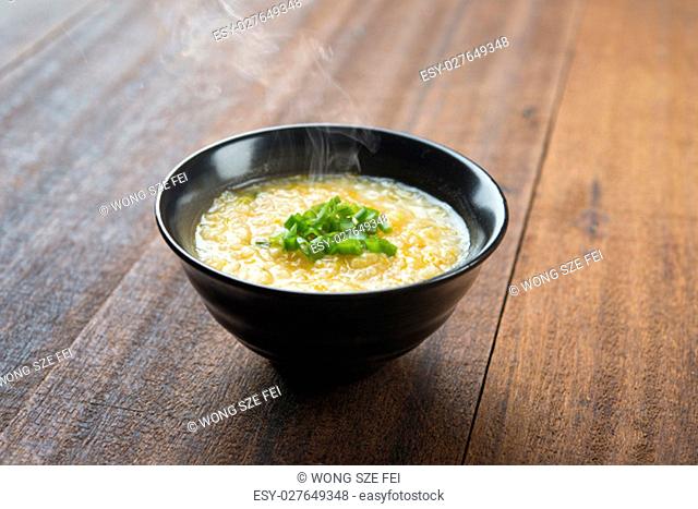 Asian style congee bowl on wooden table background