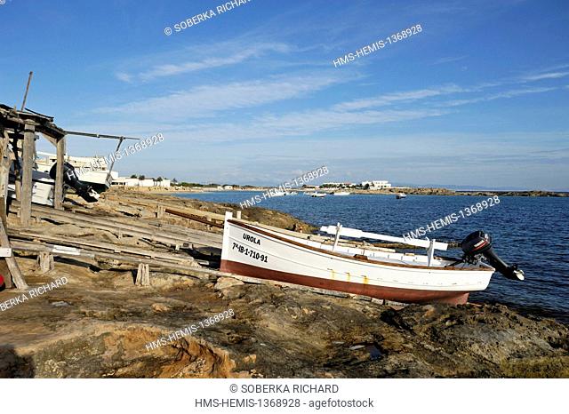 Spain, Balearic islands, Formentera, Es Pujols, boat resting on the rocks