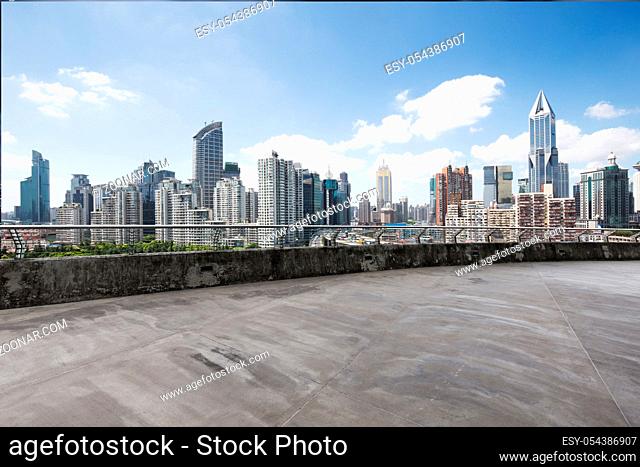 empty concrete road and cityscape of shanghai in blue sky