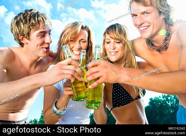 Group of very beautiful people celebrating on the beach in the summer of their lives