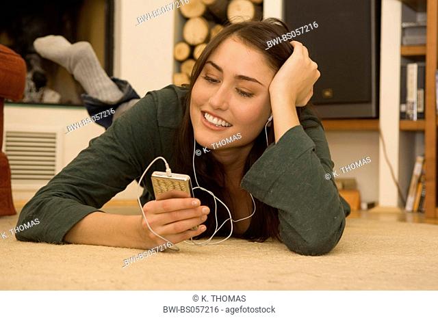 young woman, at home, listening musi with iPod
