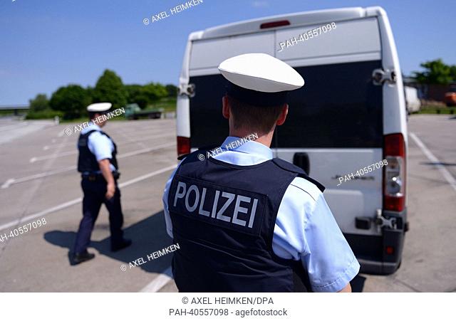 Police officers of the Federal Police check a vehicle on a parking place at Autobahn A7 near Flensburg, Germany, 07 June 2013