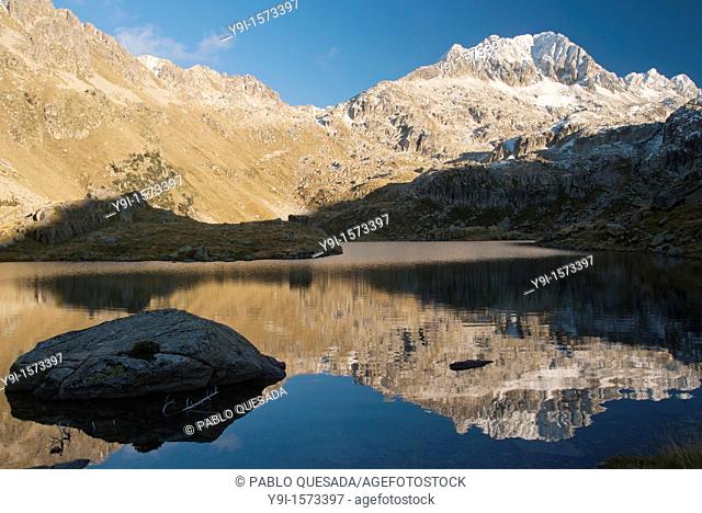 Tuc de Ratera reflected in Obago lake at the beginning of Winter, in the Colomèrs cirque, Pyrenees Mountains, Val d'Aran